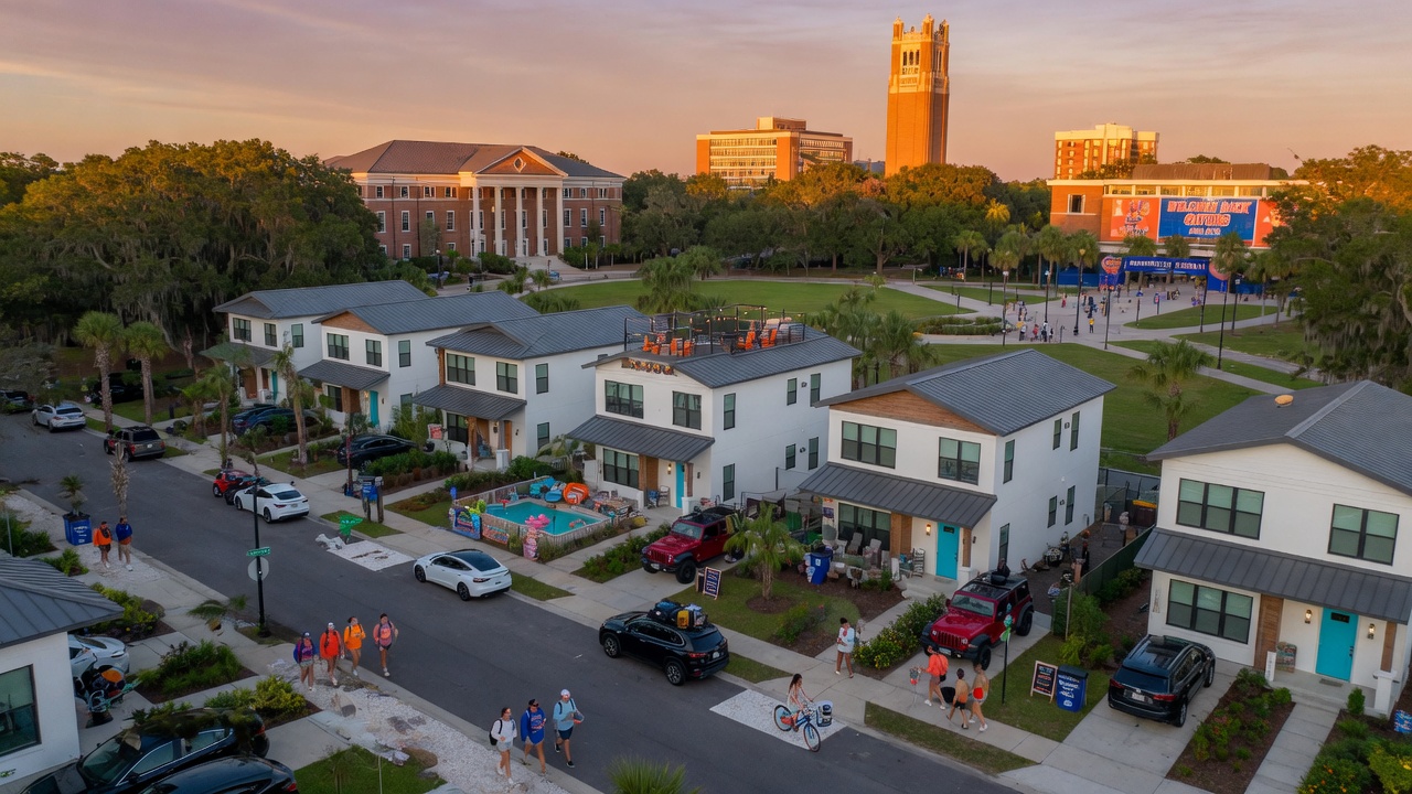 Ultra-realistic 8K aerial view of beautiful modern short term rental homes near University of Florida campus in Gainesville Florida during golden hour with students walking nearby