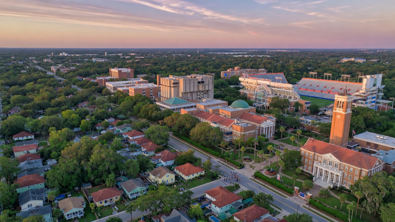 Beautiful 8K drone shot of lush green neighborhoods in Gainesville Florida showing proximity of residential areas to University of Florida campus