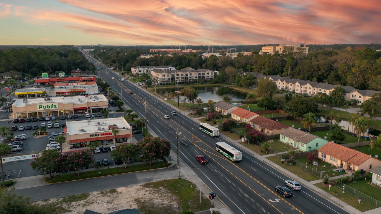 8K detailed photograph of professional drone shot showing Archer Road corridor in Gainesville with commercial and residential mix, Florida landscape